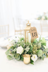 Wedding Centerpiece with Lantern and Greenery with Gold Votive Candles and Kraft Paper Table Number Tag