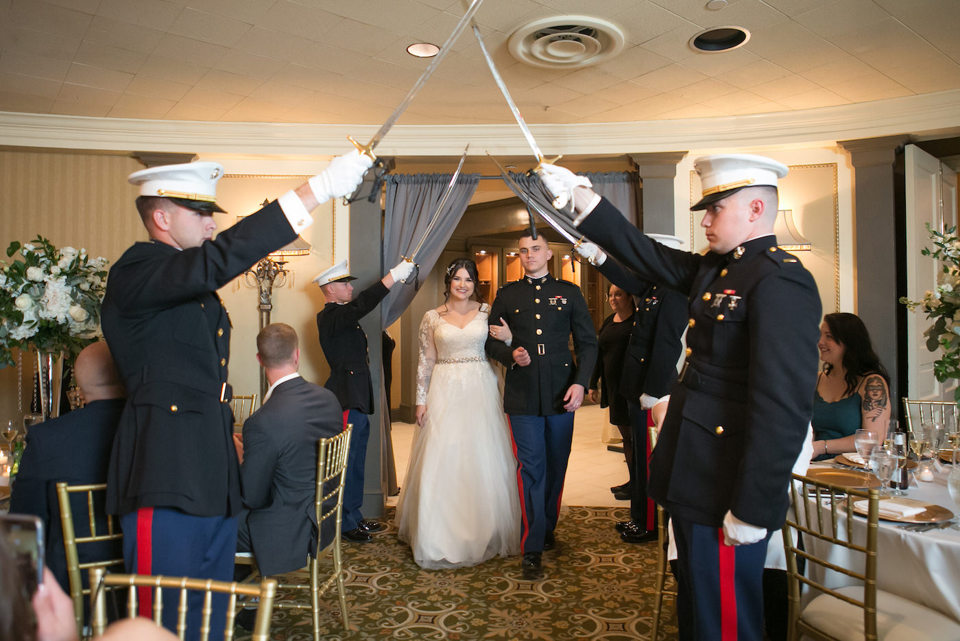 Classic Timeless Bride and Groom in Dress Blues Uniform Entering Wedding Reception Under Military Sword Arch | Wedding Photographer Carrie Wildes Photography | Ballroom Wedding Venue The Tampa Club