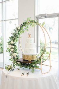 Wedding Cake Table Display with Unique Gold Moon Stand accented with Greenery Garland | Three Tier Fondant Wedding Cake with Marbled Icing