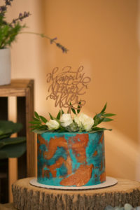 Unique One Tier Blue Teal Patina and Copper Painted Wedding Cake with White Roses and Greenery and Laser Cut Custom Cake Topper | Wedding Photographer Carrie Wildes Photography