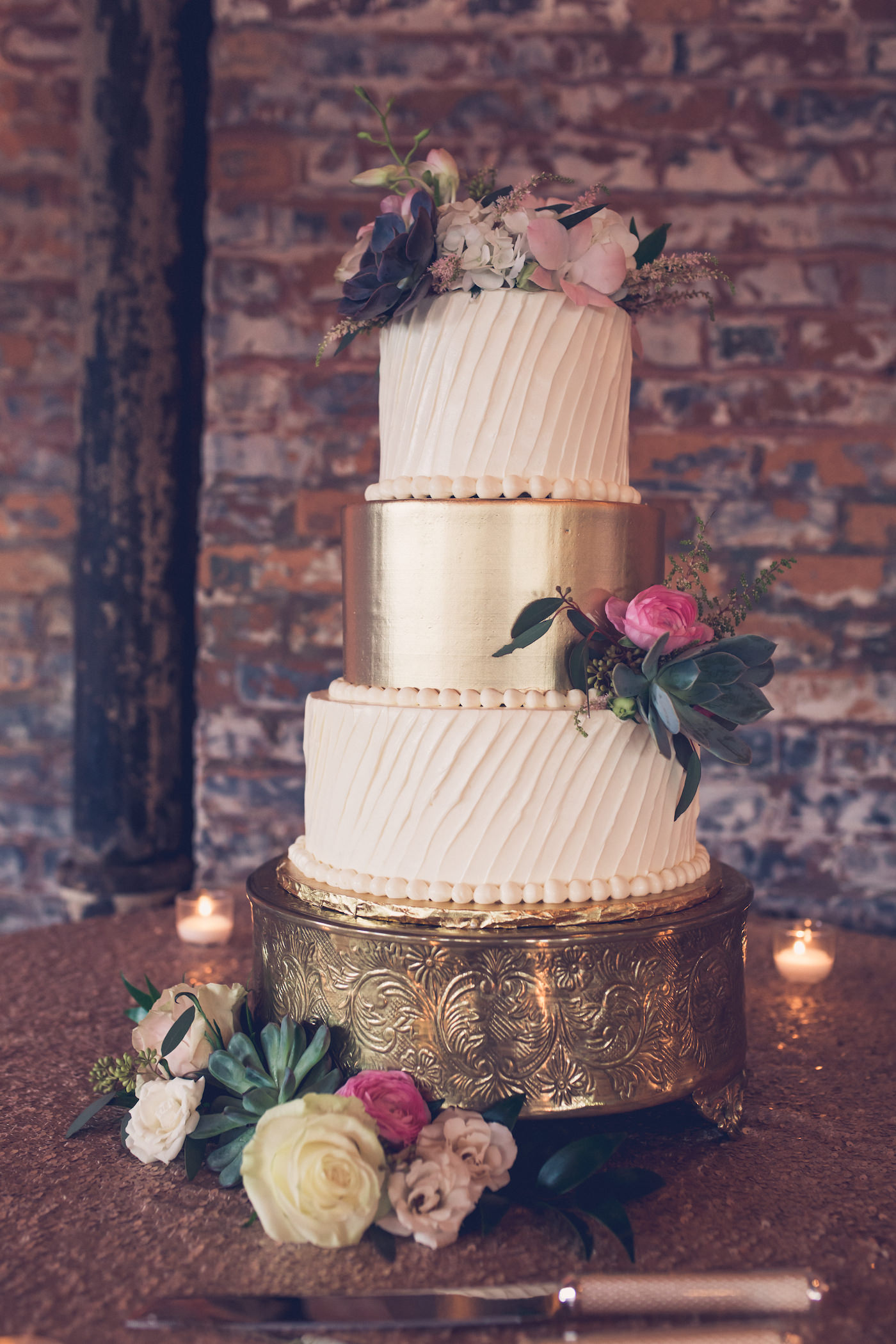 Wedding Cake Table with Champagne Rose Gold Sequin Linen and Votive Candles | Three Tier Gold and Ivory Textured Buttercream Wedding Cake with Fresh Flowers on Round Ornate Gold Cake Stand | Tampa Wedding Bakery The Artistic Whisk