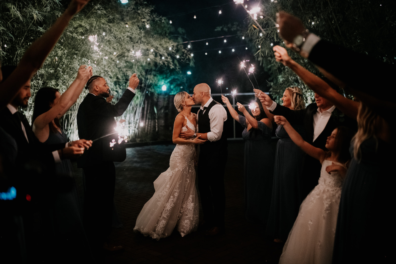 Tampa Bay Bride and Groom Kiss During Sparkler Light Wedding Exit in Bamboo Courtyard | Unique Florida Wedding Venue NOVA 535