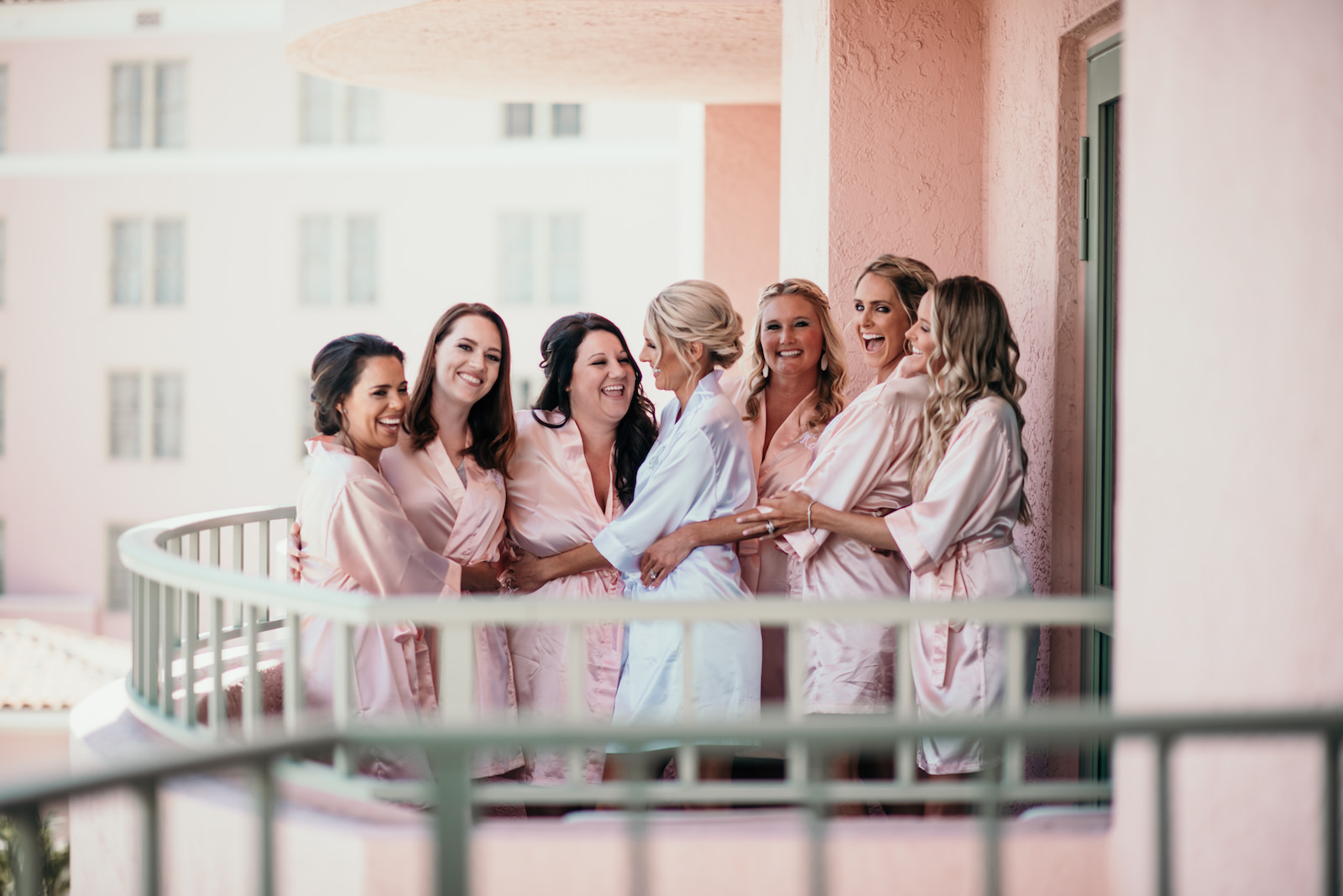 Florida Bride and Bridesmaids Getting Ready Photo on Balcony of The Vinoy Renaissance Hotel in Downtown St. Petersburg, Bridesmaids in Matching Blush Pink Silk Robes