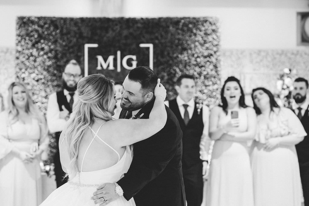 Florida Bride and Groom First Dance in Front of Monogram and Wedding Party | Tampa Bay Premier Wedding DJ Graingertainment