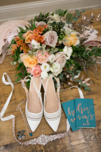 White Pointed Toe Heel Strap Wedding Shoes, Spring Colors Coral, Pink, Orange, Mauve Roses with Greenery Floral Bouquet, Green His and Hers Vows Books, Rhinestone Bridal belt | Wedding Photographer Carrie Wildes Photography