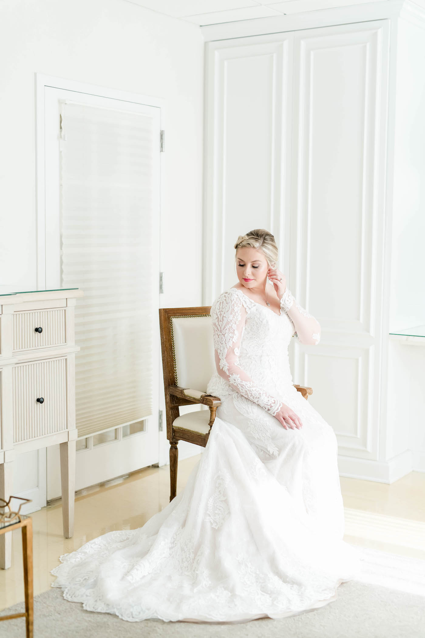 Bridal Portrait at Tampa Wedding Venue The Tampa Garden Club | Ivory Lace Long Sleeve Bridal Gown With V Neck | Side Braid Bridal Hairstyle | Femme Akoi Beauty Studio