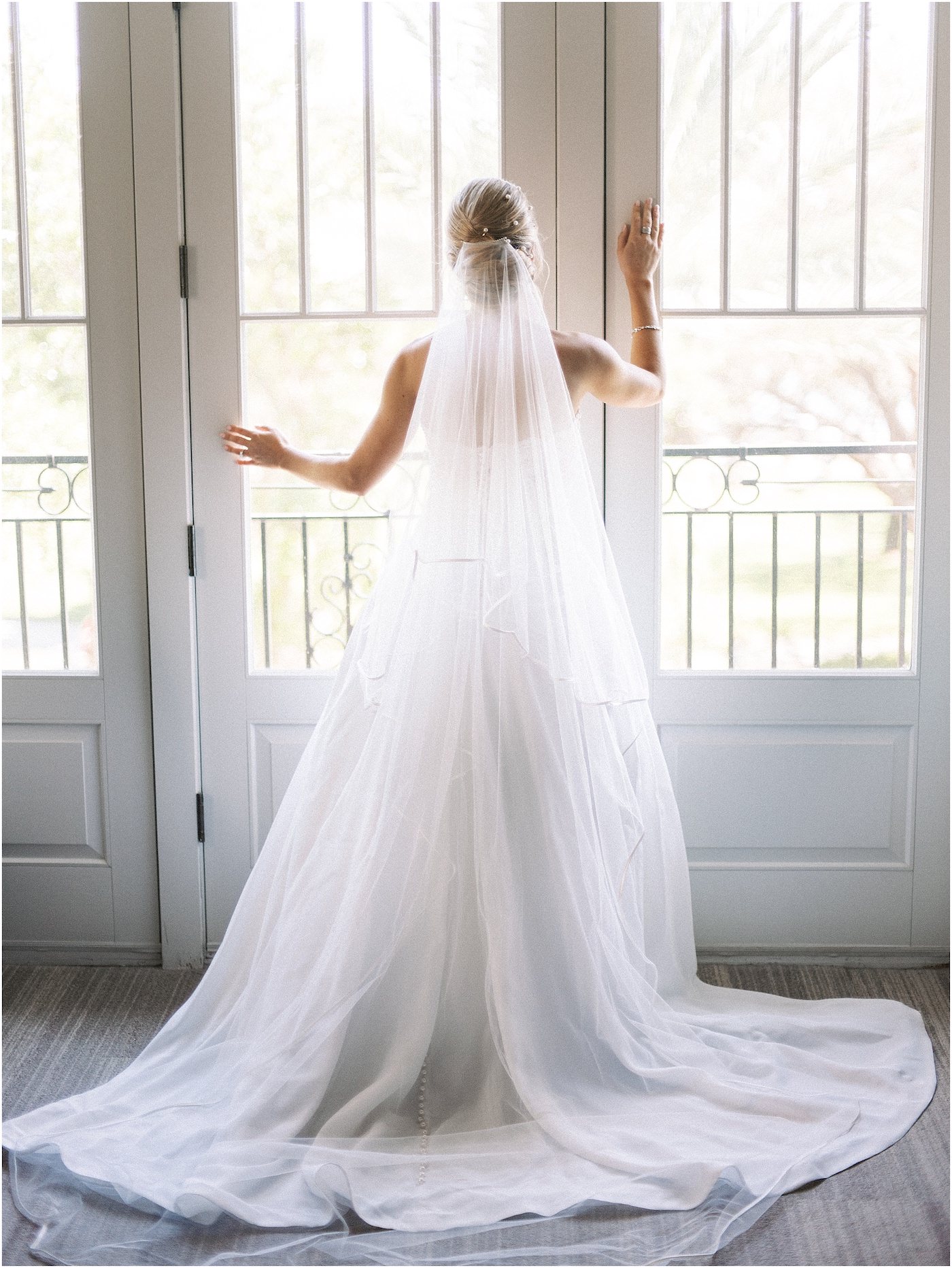 Bride Wedding Gown with Cathedral Veil Portrait in Window