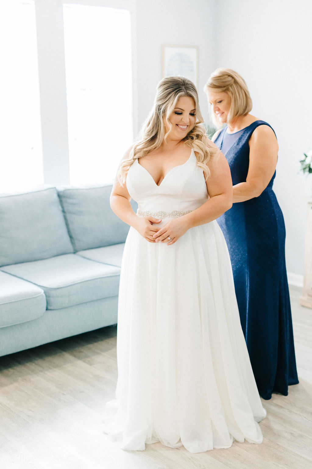 Tampa Bay Bride and Mother Getting Wedding Ready Photo, Bride in Simple White A Line Wedding Dress, Mother of Bride in Floor Length Navy Sleeveless Dress, Jana Stall