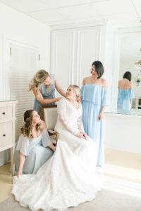 Bride and Bridesmaids Portrait Shot at Tampa Wedding Venue The Tampa Garden Club | Ivory Lace Long Sleeve Bridal Gown With V Neck | Mismatched Dusty Blue Bridesmaid Dresses | Femme Akoi Beauty Studio