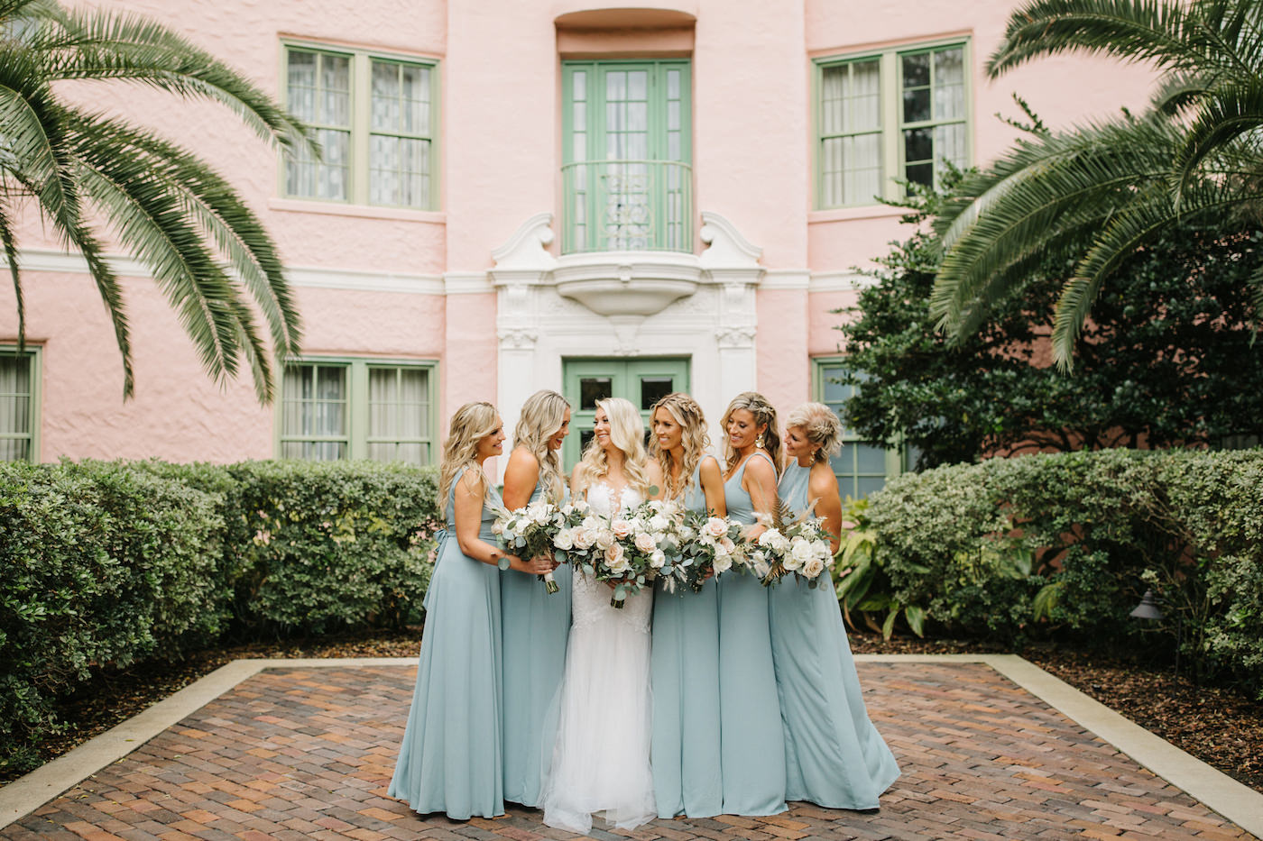Boho Chic Inspired Bride and Bridesmaids in Long Mix and Match Show Me Your Mumu in Silver Sage, Ashley Stegbauer Morrison Wearing Romantic Ines Di Santo Lace Wedding Dress, Holding Lush Ivory and Blush Pink Floral Bouquets with Greenery | Tea Garden at Vinoy Renaissance Resort in Downtown St. Petersburg | Luxury Florida Wedding and Bridal Dress Shop Isabel O’Neil Bridal Collection | Downtown St. Pete Wedding Planner Parties A’ La Carte