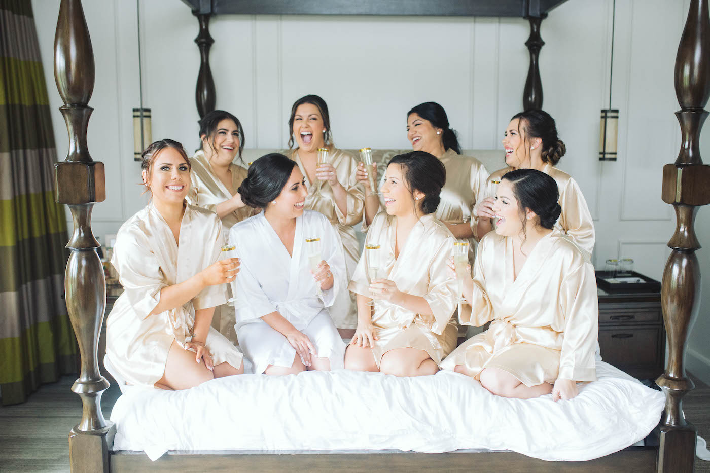 Downtown St. Petersburg Bride and Bridesmaids Getting Ready Group Photo, Bridesmaids in Matching Gold Silk Robes Toasting Champagne | Florida Boutique Hotel and Wedding Venue The Birchwood