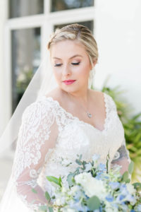 Ivory Lace Long Sleeve Bridal Gown With V Neck | Side Braid Bridal Hairstyle and Natural Wedding Makeup | Blue and White Bridal Bouquet | Femme Akoi Beauty Studio