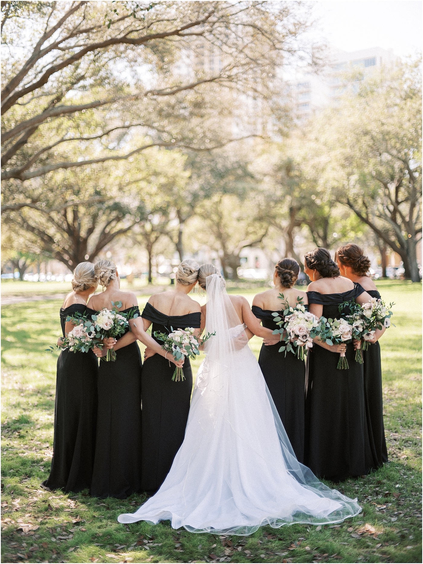 Bride and Bridesmaids Outdoor Portraits | Black Long Bridesmaid Dresses with Black and White Anemone and Greenery Bouquets | Tampa Bridesmaids Dress Store Bella Bridesmaids
