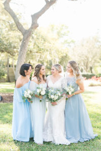 Bride and Bridesmaids Outdoor Garden Portrait | Bridesmaids in Mismatched Light Blue Long Chiffon Dresses | Blue and White Wedding Bouquets | Femme Akoi Beauty Studio