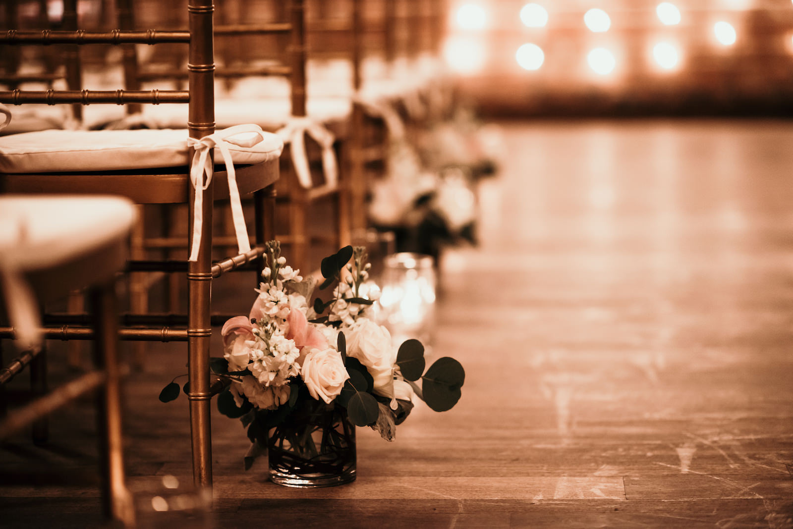 Romantic Wedding Ceremony Decor, Small Floral Arrangements on Aisle, White Roses, Blush Pink Flowers, Baby's-breath, and Eucalyptus Leaves, Gold Chiavari Chairs | Florida Wedding Venue NOVA 535