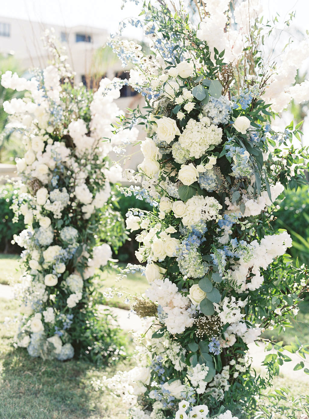 Luxurious, Garden Inspired Wedding Ceremony Decor, Lush Ivory Flowers, White Roses, Blue Hibiscuses, Thistle, Baby's Breath, and Greenery | Florida Destination Wedding Planner NK Productions Wedding Planning