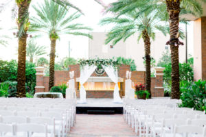 Simple Classic New Year's Eve Wedding Ceremony Decor, Arch with White Draped Linens, Greenery Arrangement and White Florals, Red Brick Fireplace Backdrop, Tampa Agliano Park Courtyard | Wedding Photographer Shauna and Jordon Photography | Wedding Planner UNIQUE Weddings + Events | Wedding Rentals A Chair Affair
