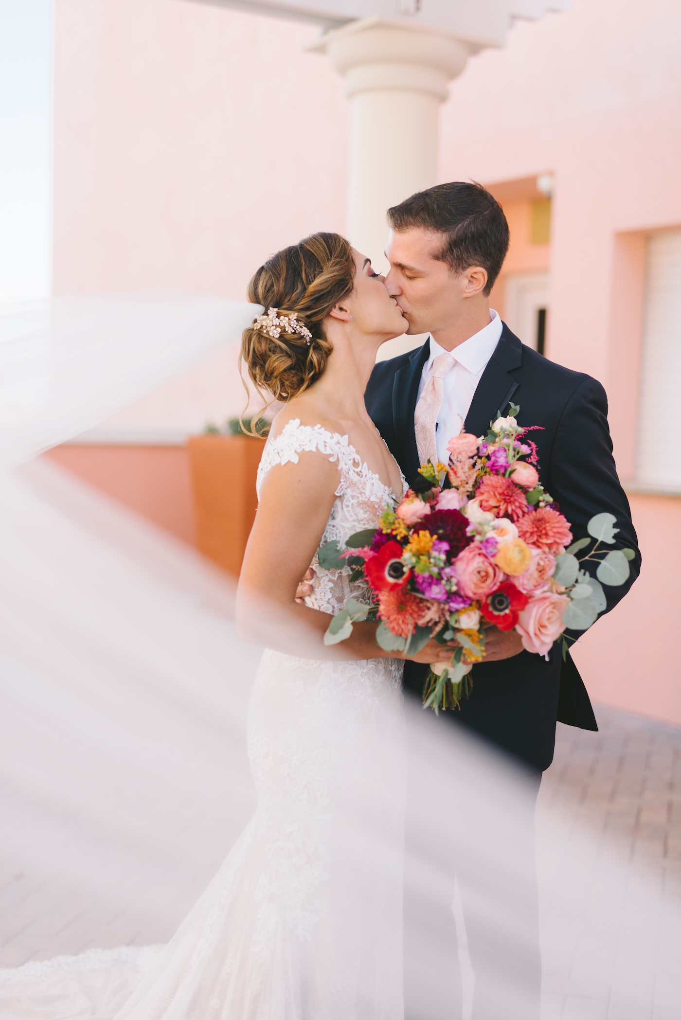 Bride and Groom Portrait at Clearwater Wedding Venue Hyatt Regency Beach Hotel | Wedding Photography Veil Shot | Bright Tropical Colorful Wedding Bouquet | Tampa Bay Wedding Photographer Kera Photography
