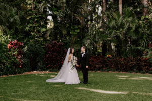 Bride and Groom Outdoor Garden Wedding Portraits | St. Pete Wedding | Lace and Organza Wedding Dress Bridal Gown with Cathedral Veil | Groom in Classic Black Tuxedo Suit with Bow Tie