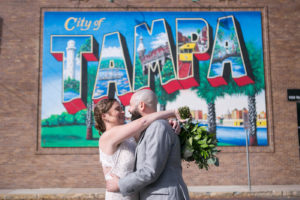 Florida Bride and Groom Outside of City of Tampa Mural on Red Brick Building | Wedding Photographer Carrie Wildes Photography