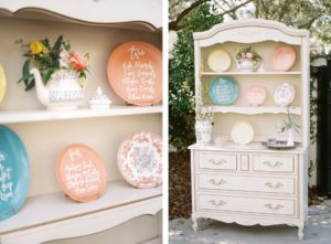 Vintage Furniture Hutch Display with Hand Written Table Plan Plates Seating Chart | Tampa Styled Shoot European Pastel Spring Wedding Inspiration