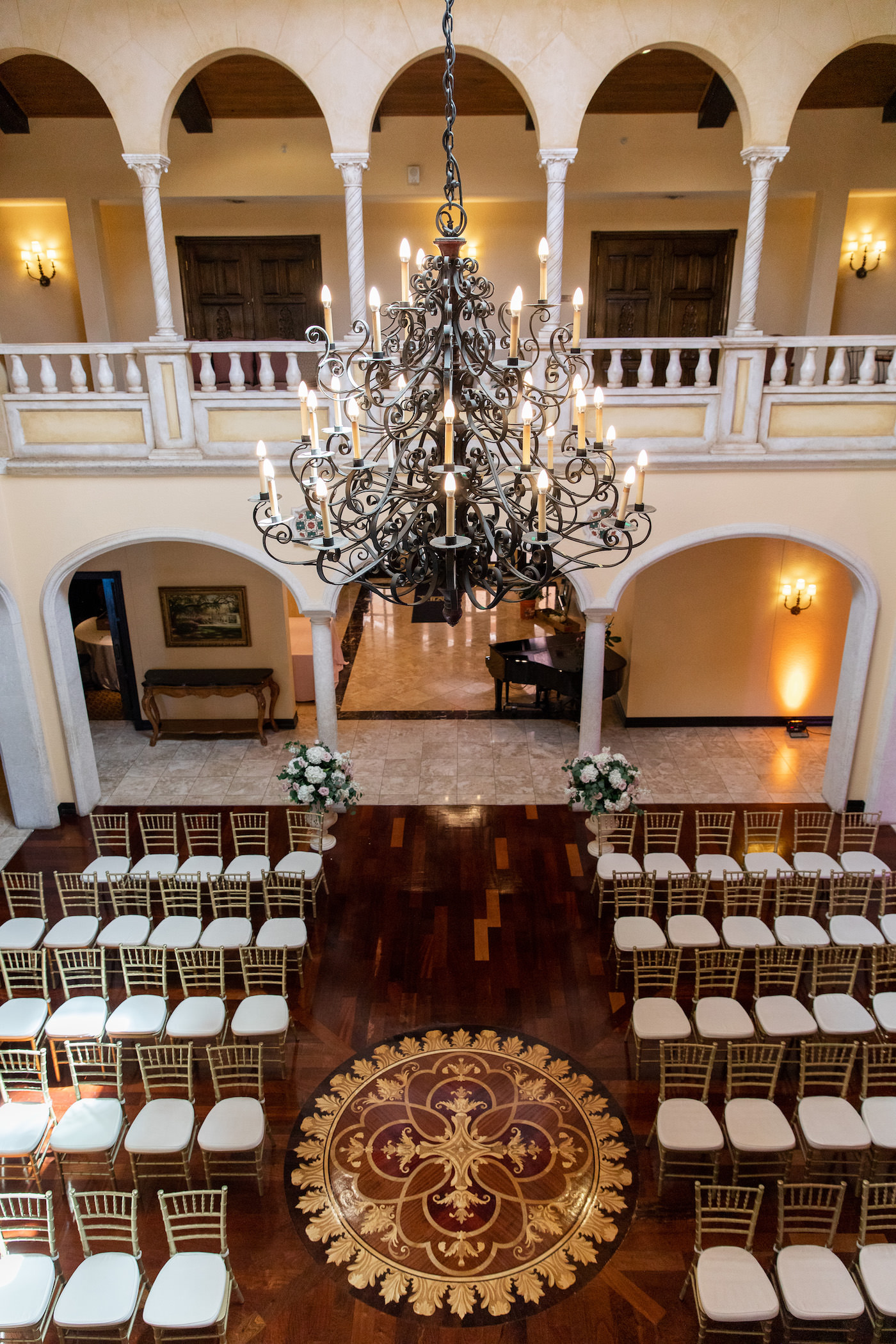 Tampa Wedding Venue Avila Golf & Country Club Indoor Ceremony with Gold Chiavari Chairs and Crystal Chandelier
