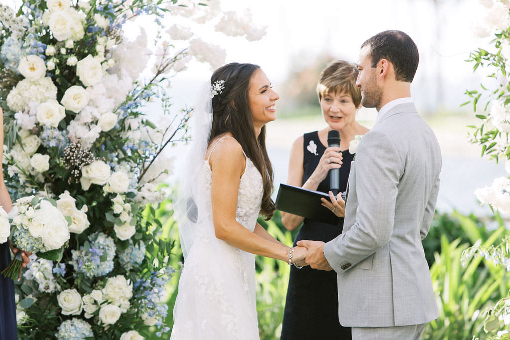 Bride and Groom Exchange Vows in Outdoor Garden Lawn Ceremony at Ritz Carlton Sarasota | Sarasota Wedding Officiant A Wedding With Grace | Florida Destination Wedding Planner NK Productions Wedding Planning