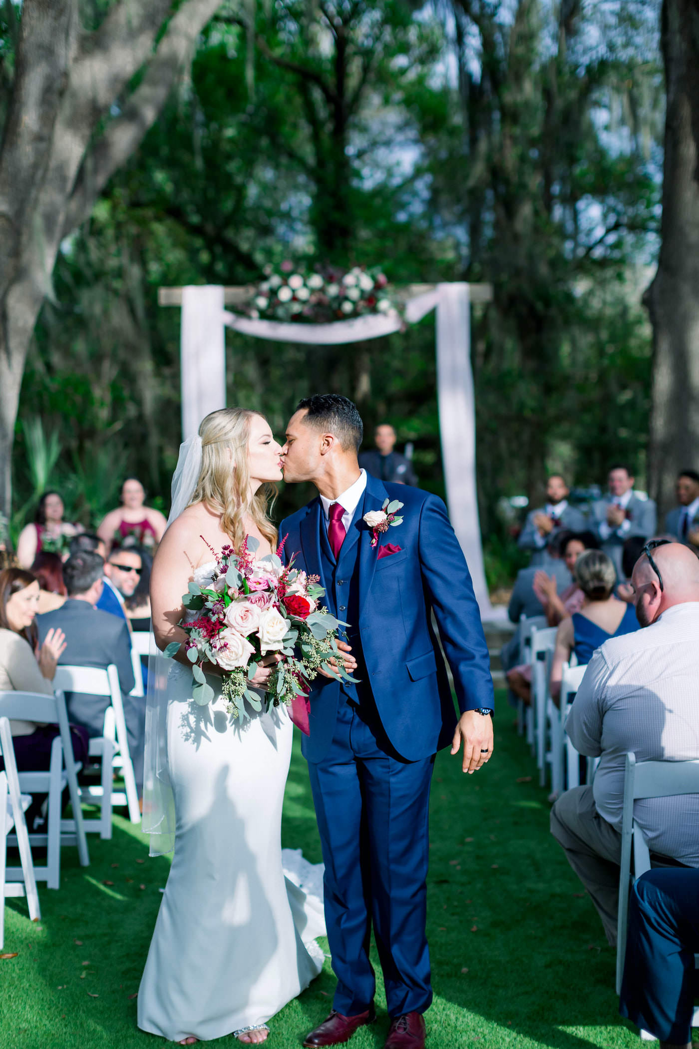 Bride and Groom Walking Down the Aisle after Outdoor Florida Ceremony | Burgundy and Blush Pink Wedding | Navy Blue Groom Suit
