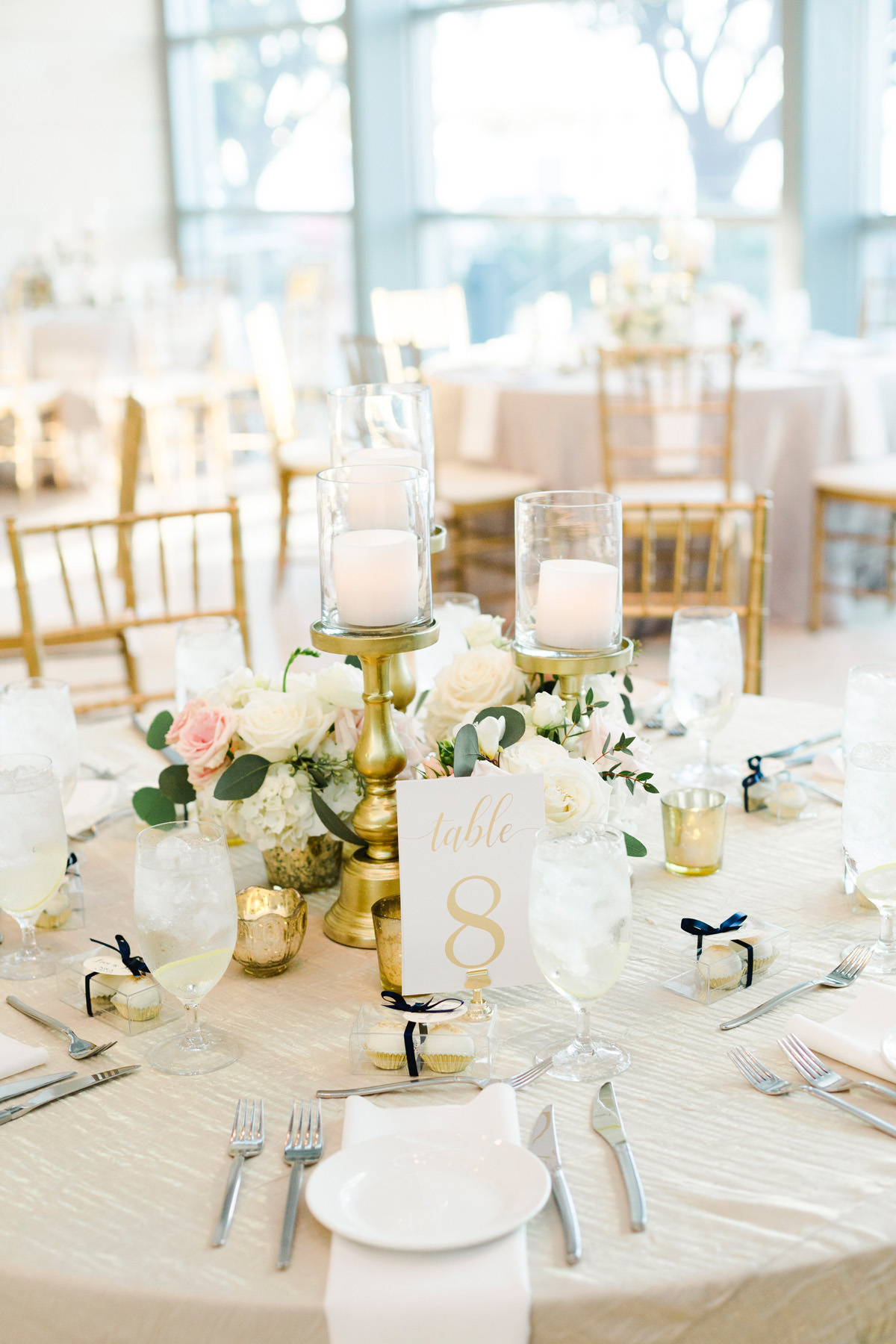 Indoor Wedding Reception Tables with Gold Chiavari Chairs and Gold Candlestick Centerpieces with White Hydrangea and Blush Pink Roses and Eucalyptus Greenery | Bruce Wayne Florals