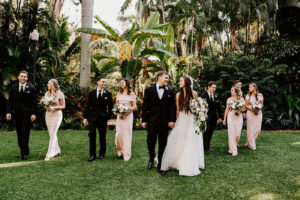 Wedding Party Outdoor Garden Portrait | Groom and Groomsmen in Classic Black Tuxedo Suits | Blush Pink Off The Shoulder Long Elegant Bridesmaid Dresses by After Six | Bride and Bridesmaids Outdoor Portrait | White and Blush Pink Rose and Greenery Bouquets by St. Pete Wedding Florist Monarch Events and Design