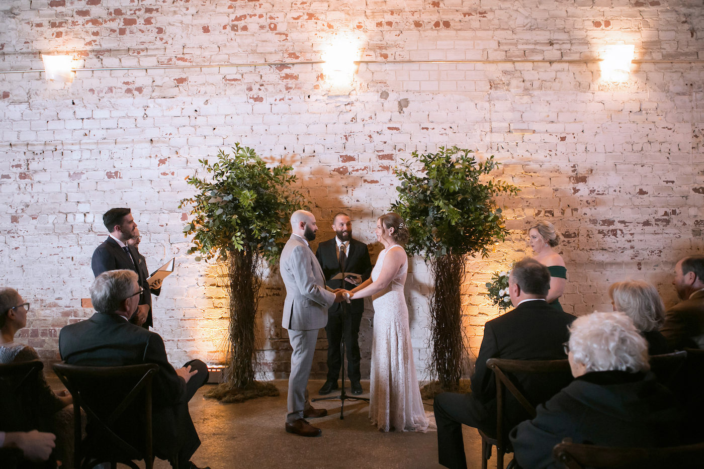 Unique Wes Anderson Ceremony Decor, Curly Willow Trees, Uplighting, White Brick Wall | Wedding Photographer Carrie Wildes Photography | Tampa Bay Wedding Venue Rialto Theatre | Wedding Florist Monarch Events and Design | Wedding Planner UNIQUE Weddings and Events