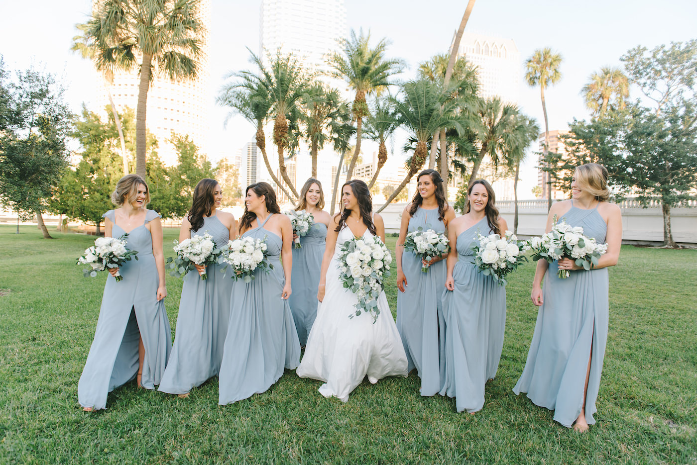 Classic Elegant Florida Bride in A-Line V Neck Wedding Dress with Lush White Roses and Greenery Floral Bouquet, Bridesmaids in Mix and Match Dusty Blue Dresses | Tampa Bay Wedding Photographer Kera Photography