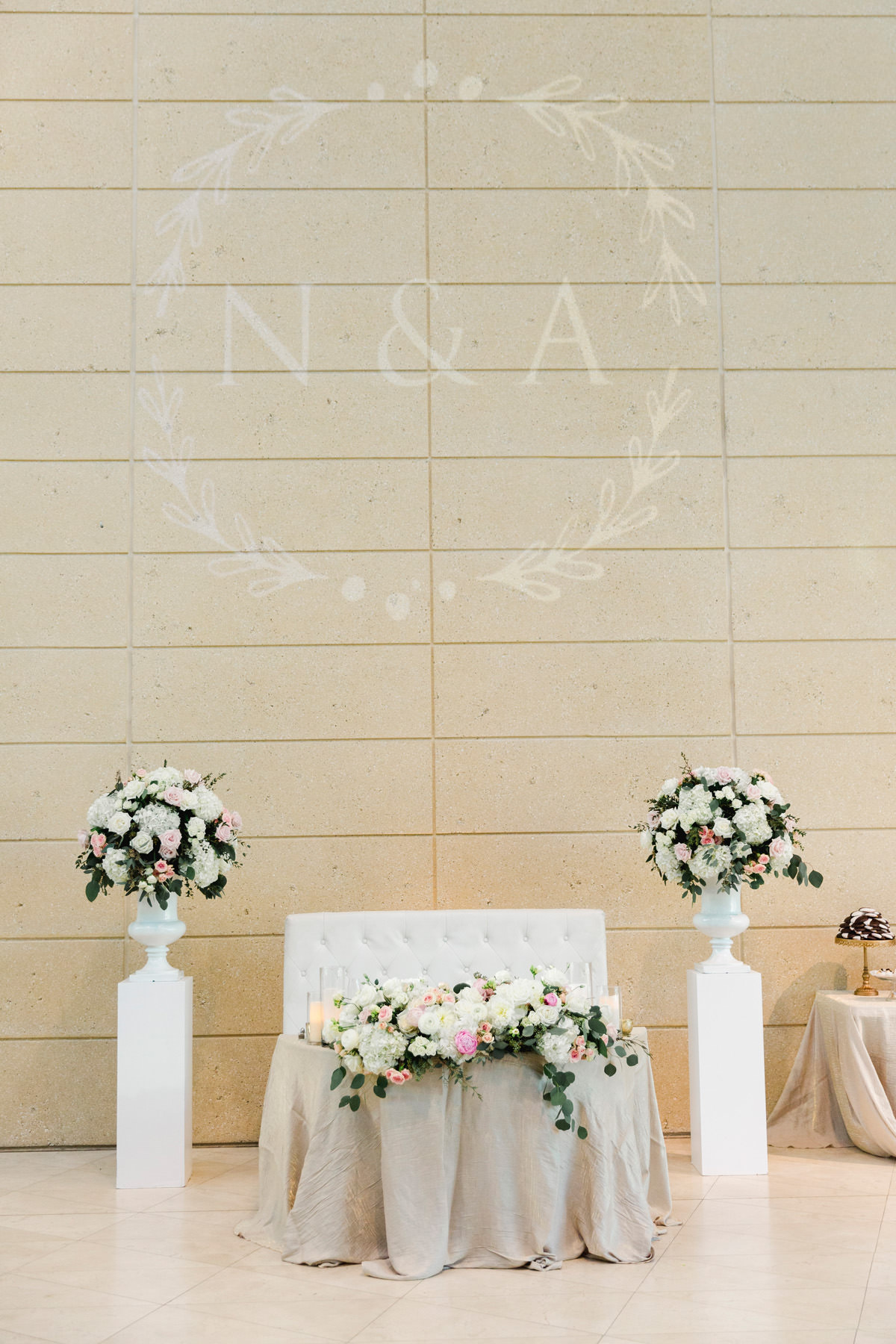 Wedding Sweetheart Table with Loveseat and Floral Centerpieces on Columns and Floral Halo Monogram Gobo | Bruce Wayne Florals | Rentals Gabro Event Services