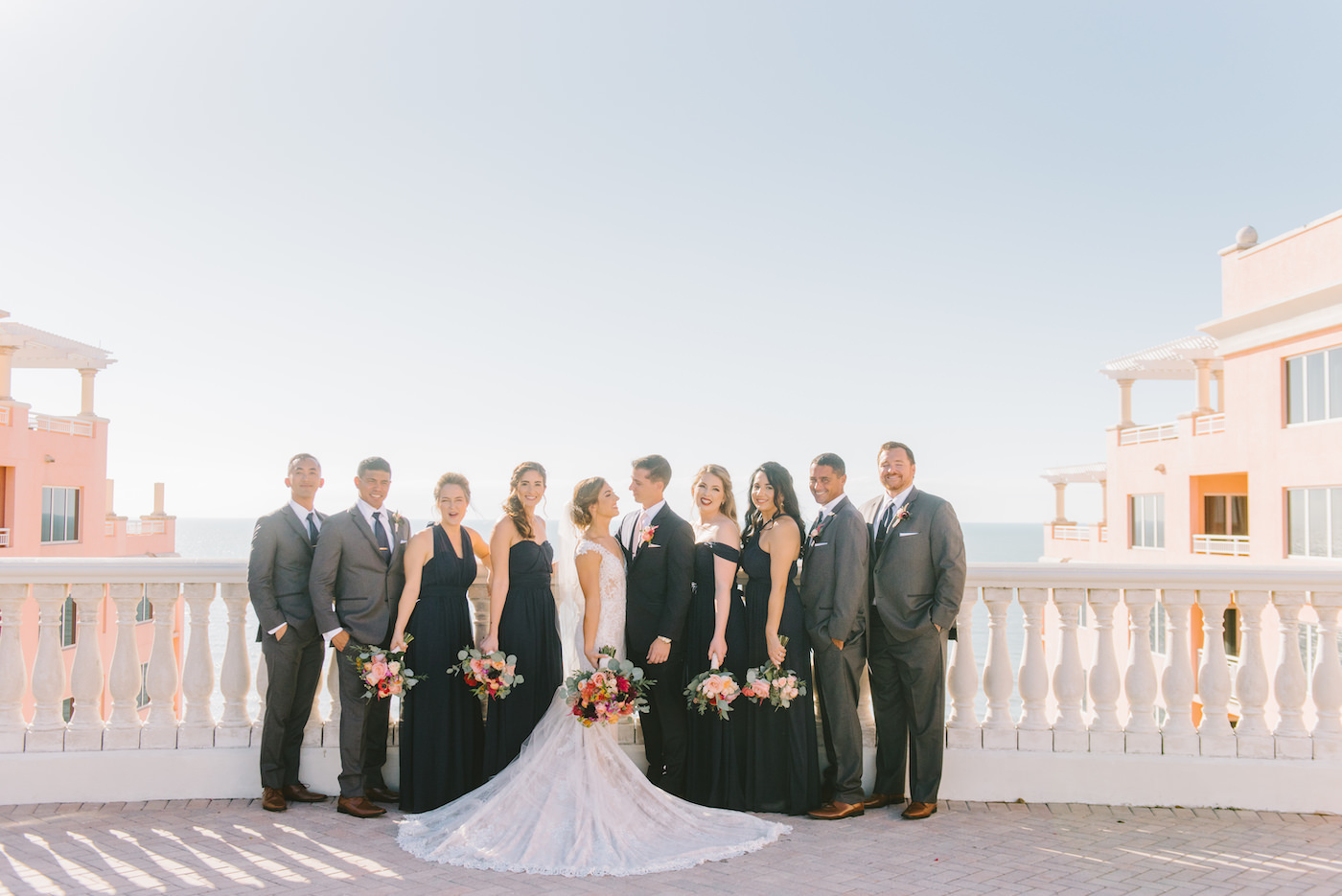 Wedding Party Portrait on Outdoor Rooftop | Bridesmaids in Black Long Dresses with Bright Colorful Bouquets and Groomsmen in Grey Suits | Tampa Bay Wedding Photographer Kera Photography