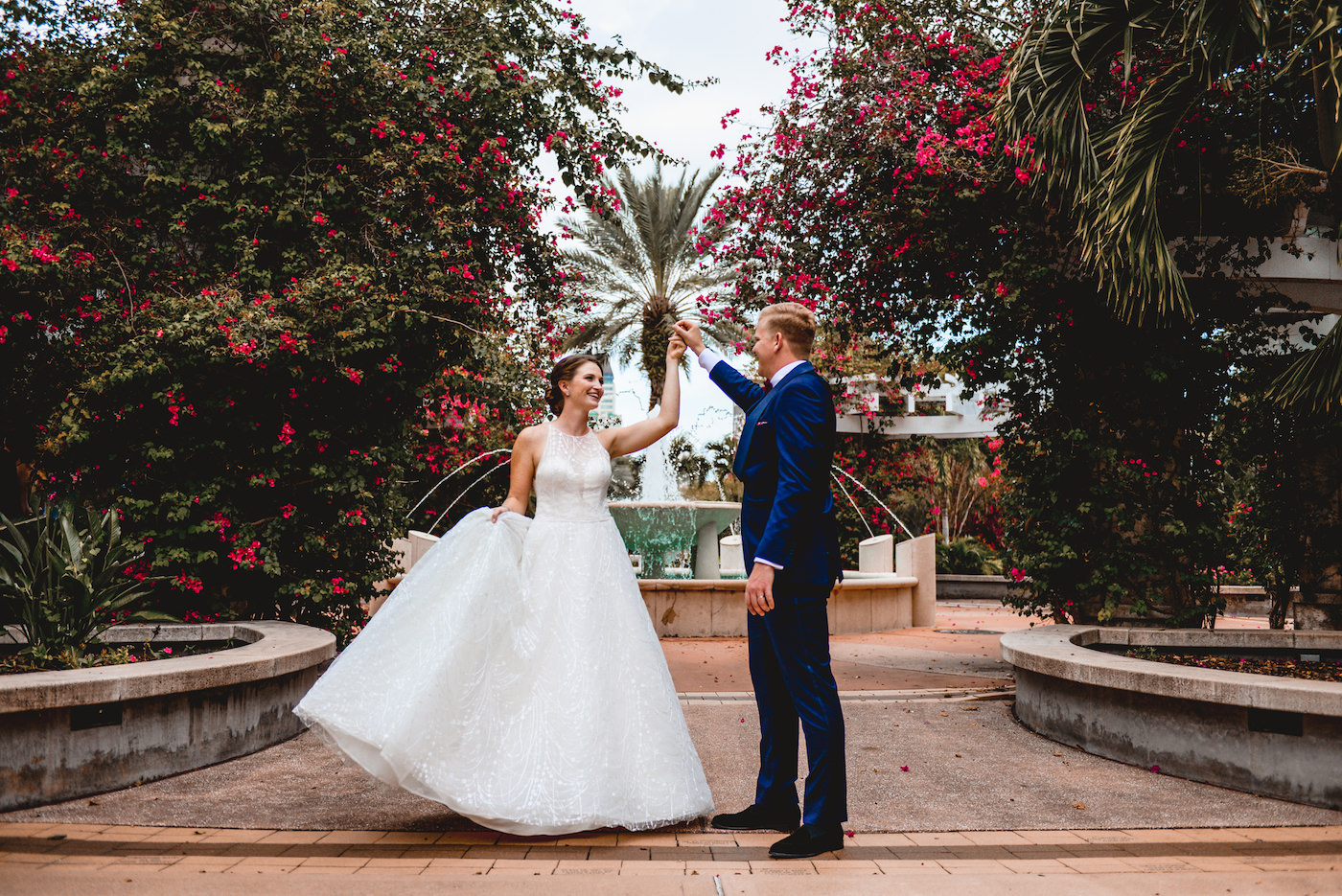 Bride and Groom Outdoor Portrait at St. Pete Wedding Venue The Poynter Institute | White Embroidered Organza Ballgown Illusion Neck Bib Neckline Bridal Gown | Groom Classic Navy Blue Suit | Tampa Wedding Dress Shop Truly Forever Bridal