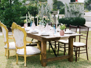 Outdoor Reception Wood Farm Table with Vintage Furniture Mismatched Chairs | Tampa Styled Shoot European Pastel Spring Wedding Inspiration