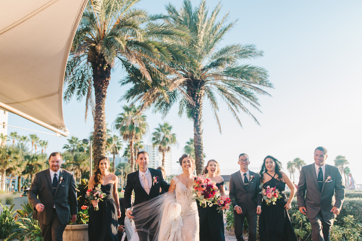 Clearwater Wedding Party Portrait | Bridesmaids in Black Long Dresses with Bright Colorful Bouquets and Groomsmen in Grey Suits | Tampa Bay Wedding Photographer Kera Photography