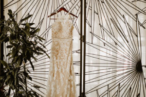 Wedding Dress Hanger Shot | Champagne Lace Sheath Illusion Neck Bridal Gown