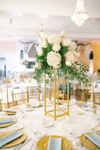 Classic Elegant Wedding Reception Decor, Tall Modern Geometric Gold Stand with Lush White Hydrangeas, Roses and Greenery, Eucalyptus Centerpiece, Gold Chargers with Dusty Blue Linen Napkins | Tampa Bay Wedding Photographer Kera Photography | Wedding Rentals Outside the Box Rentals | Wedding Planner Breezin' Weddings | Historic Wedding Venue The Orlo