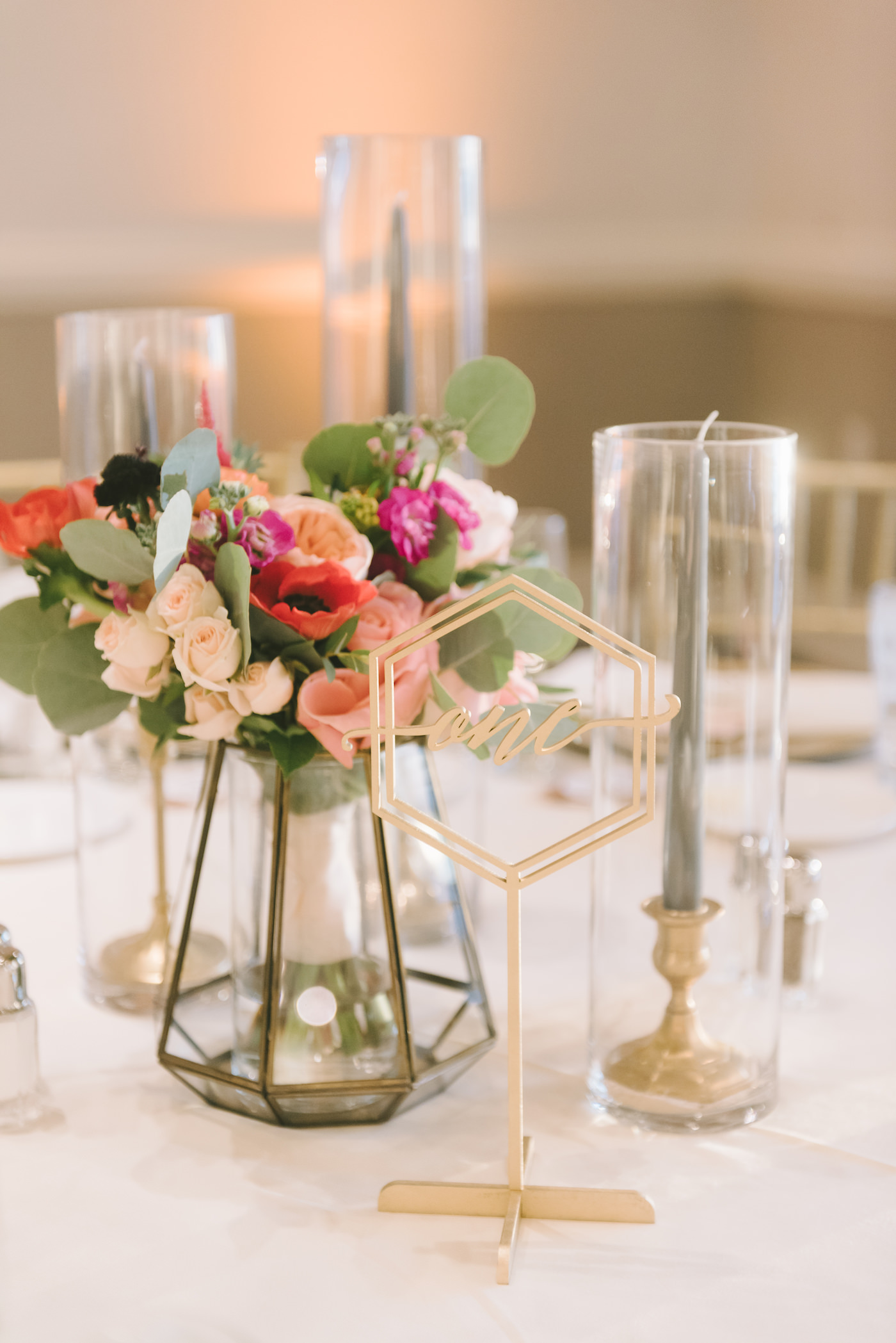 Small Colorful Centerpiece with Geometric Vase and Gold Candlesticks and Die Cut Gold Table Numbers