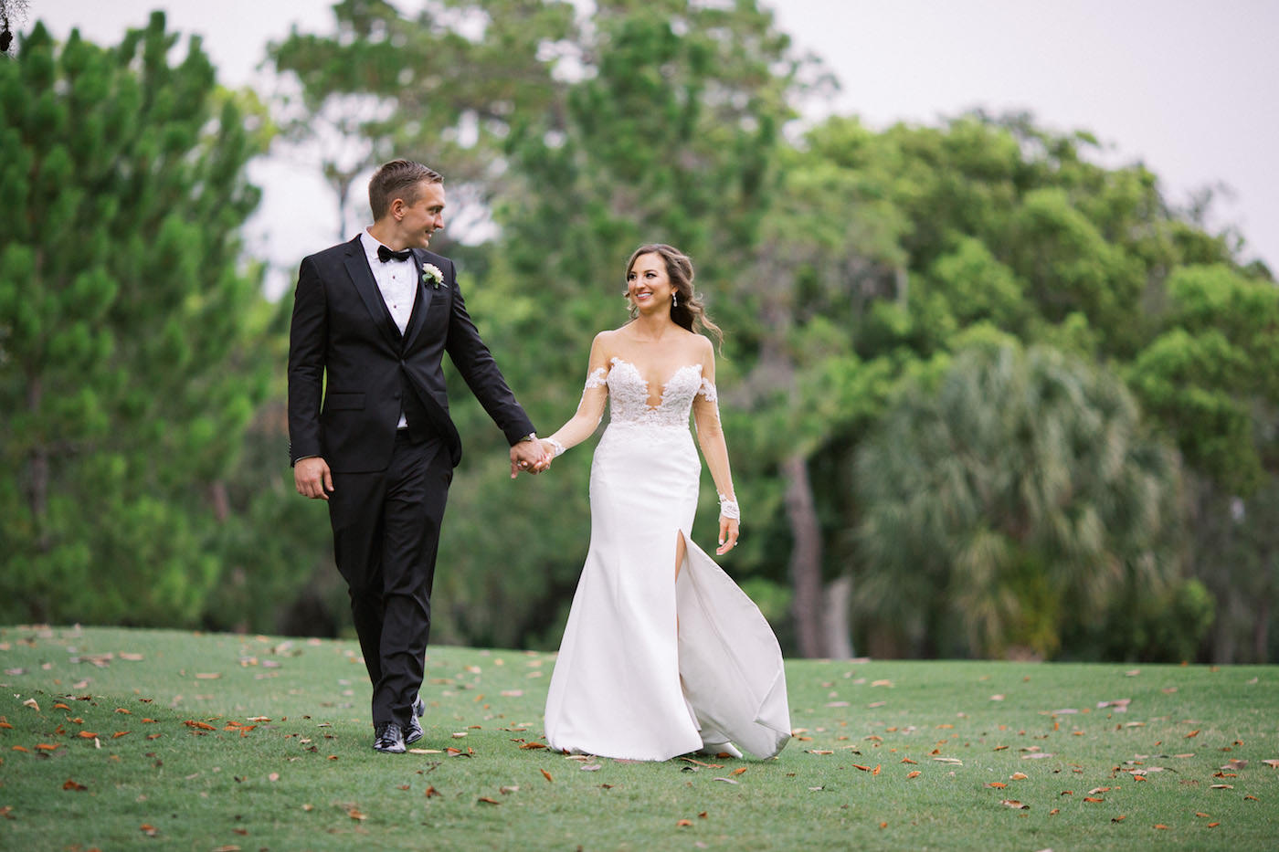 Ines di Santo Designer Bridal Gown Illusion Lace Sexy Wedding Dress | Outdoor Bride and Groom Portraits at Tampa Golf Course Putting Green | Groom in Classic Black Tux Suit with Bow Tie | Isabel O'Neil Bridal Collection
