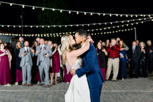 Outdoor Florida Wedding Reception Dance Floor with Canopy String Lights | Bride and Groom First Dance Kiss
