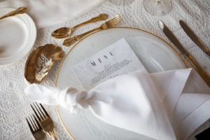 Elegant Wedding Reception Decor, Gold Rimmer Charger, White Menu Gold Flatware and Gold Pained Oyster Shell Place Card | Tampa Bay Wedding Planner Parties A'la Carte