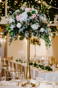 Tall Wedding Centerpiece with White Hydrangea and Blush Pink Roses and Eucalyptus Greenery on top of Gold Candlestick | Monarch Events and Design