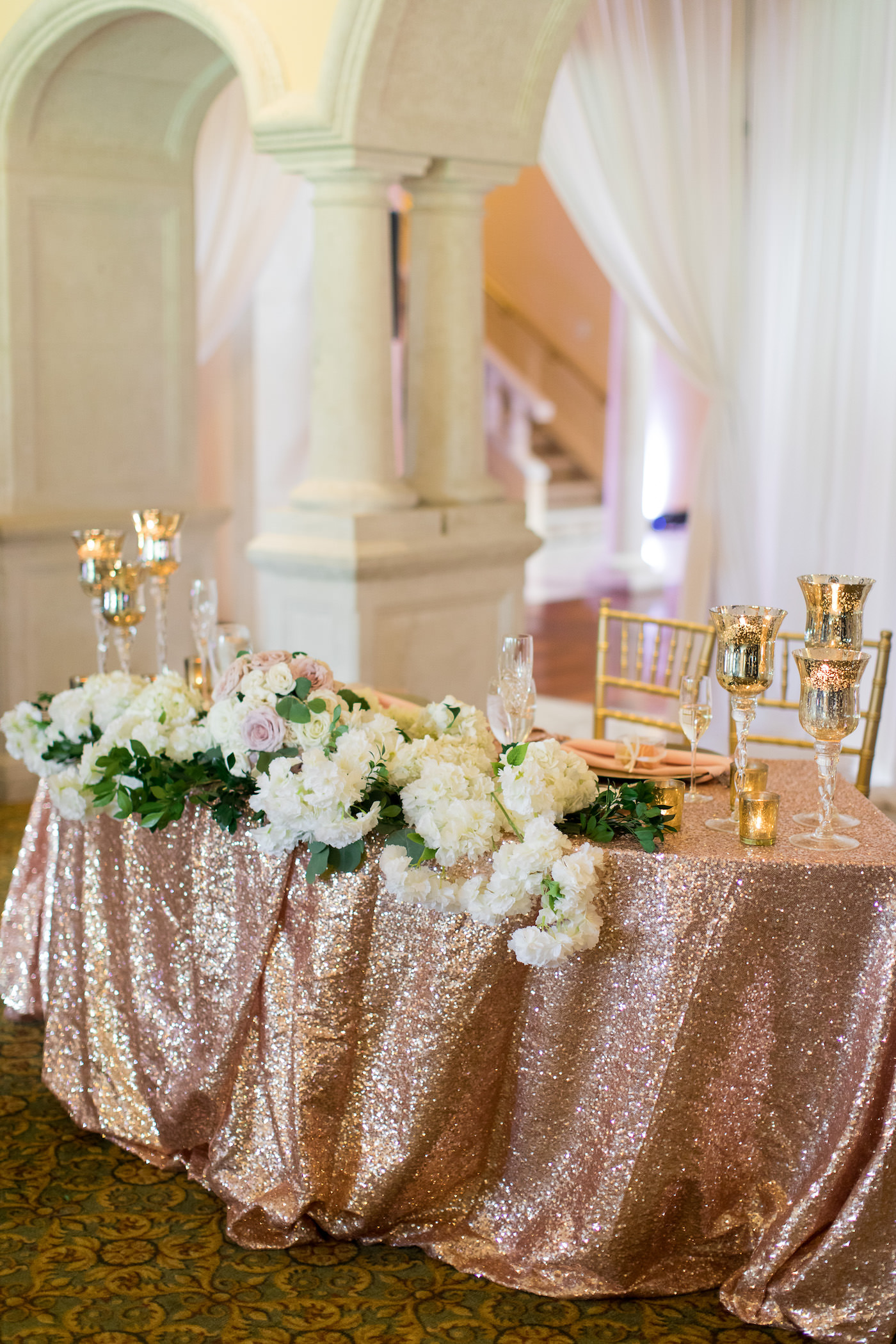 Tampa Wedding Sweetheart Table with Blush Pink Rose Gold Sequin Table Linen and Gold Mercury Candles with Ivory Hydrangea Floral Arrangement