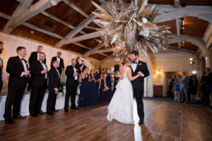 Romantic Whimsical Bride and Groom First Dance Portrait Under Unique Pampas Grass and Dried Palm Tree Leaves Chandelier | Tampa Bay Wedding Planner Parties A'la Carte