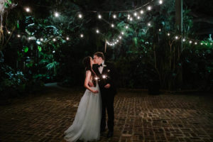 Bride and Groom Outdoor Night Portrait Shot with Sparklers and Canopy String Lights