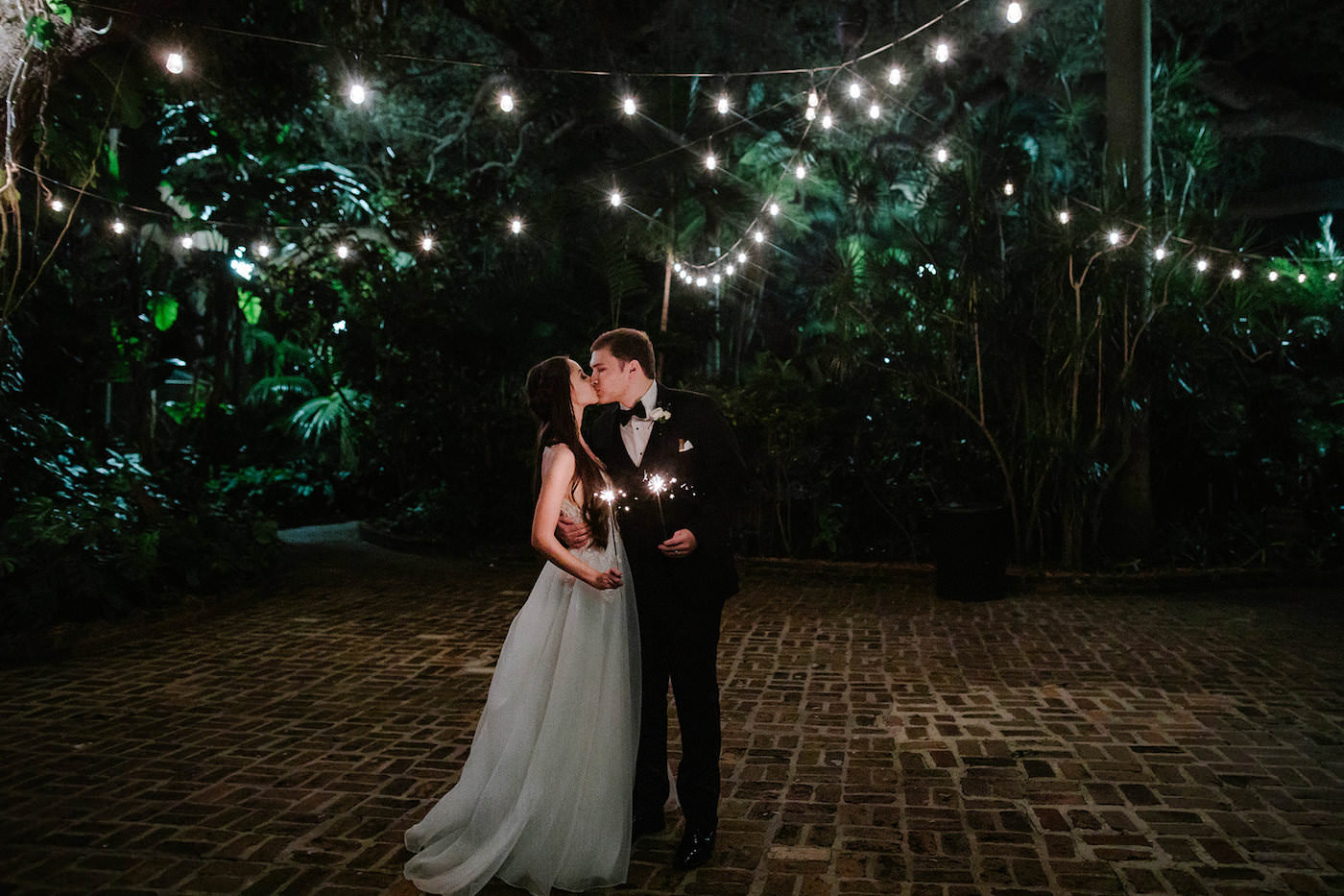 Bride and Groom Outdoor Night Portrait Shot with Sparklers and Canopy String Lights