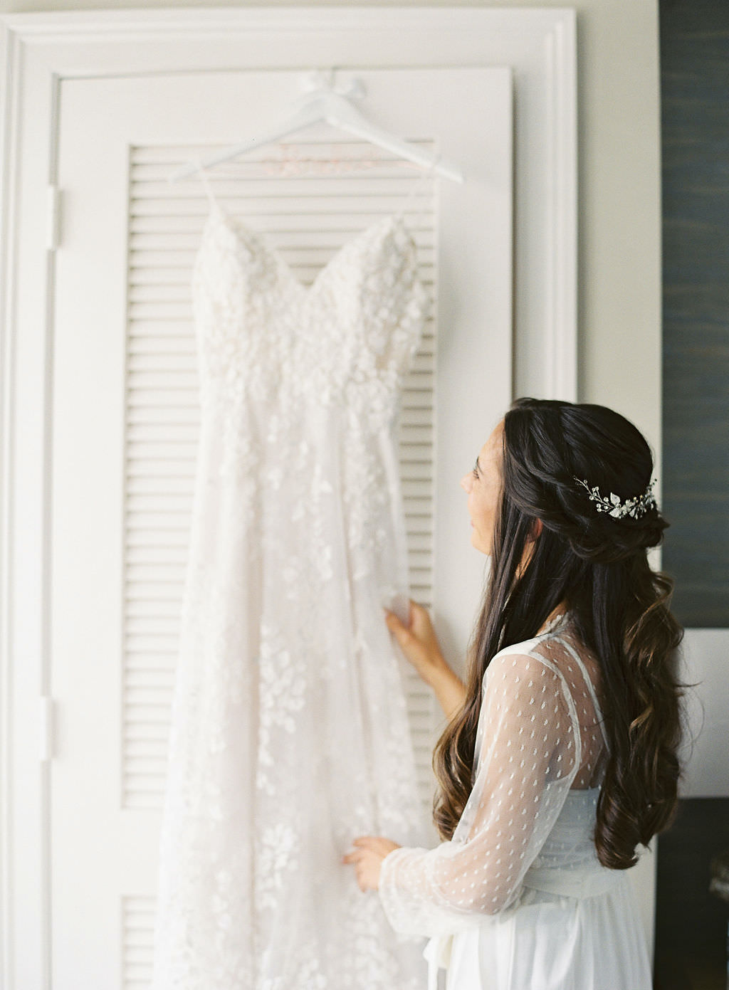 Sarasota Bride Admiring Her Hanging Lace Lazaro Wedding Dress
