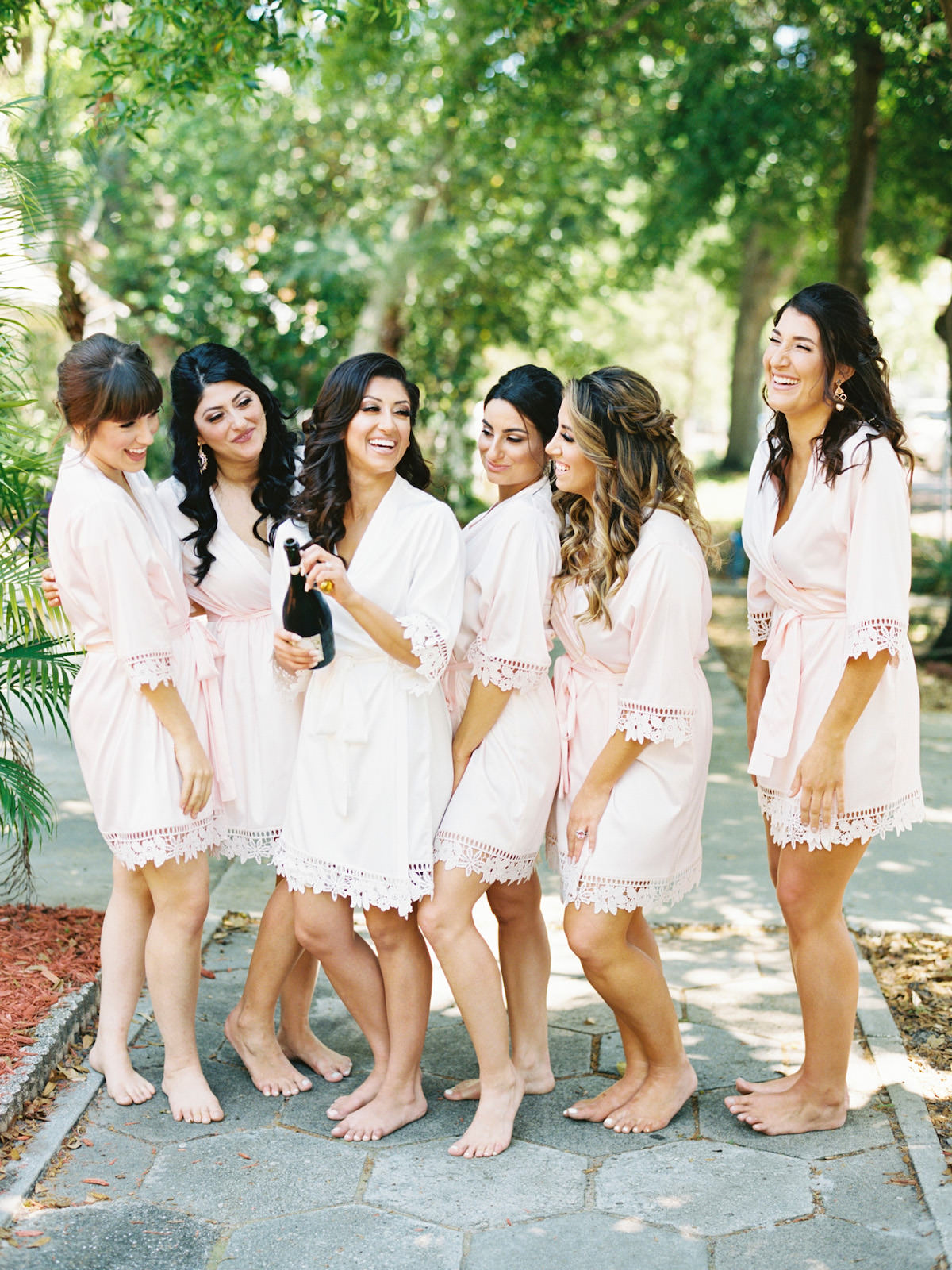 Bride and Bridesmaids Getting Ready and Popping Champagne in Blush Pink Robes